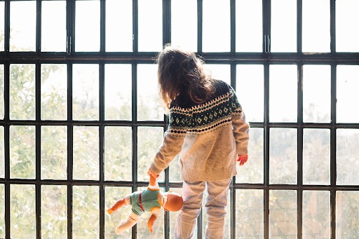 Girl looking through an invisible grille