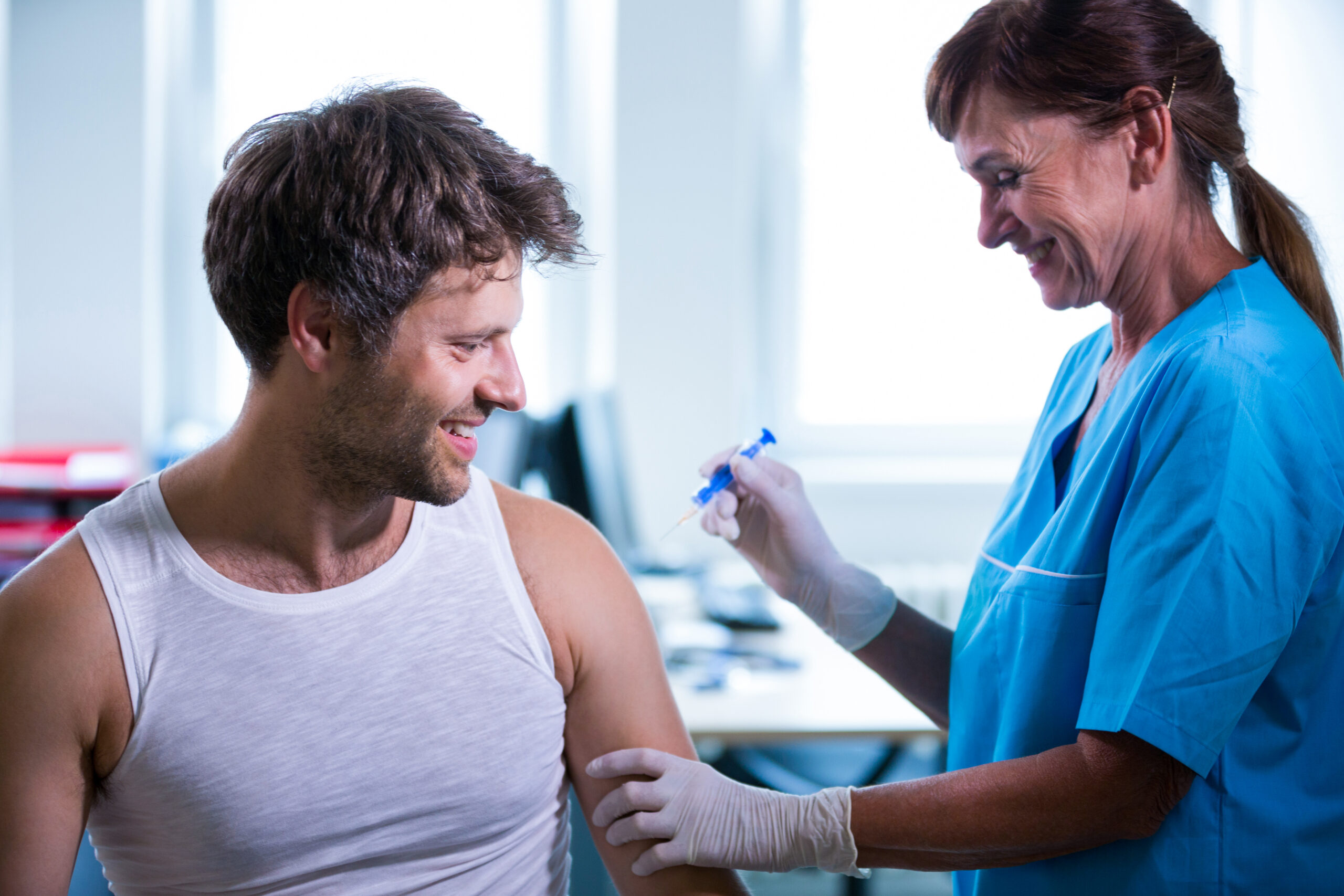 A doctor administering a pain relief injection to a patient