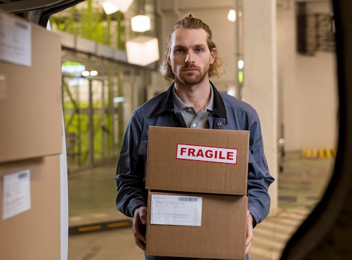 Courier Holding Fragile Boxes